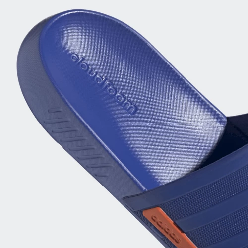 Tendance et Polyvalence: Adoptez la Claquette Racer TR Adidas pour un Look Sans Effort Photo de la claquette sur un fond coloré, mettant en valeur son design moderne